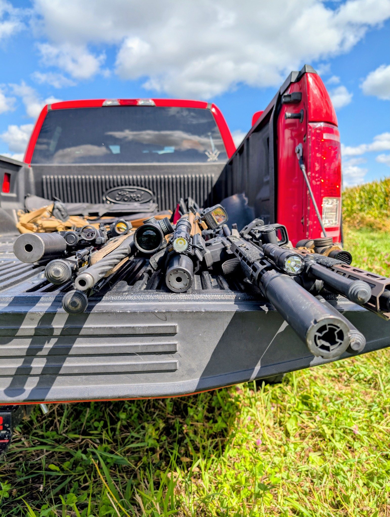 Firearms and equipment displayed on a truck tailgate